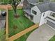Aerial view of a backyard with lush green grass, a wooden fence, and a modern home at 3822 Topsfield Rd, Charlotte, NC 28211