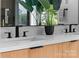 Modern bathroom featuring a double vanity with sleek black faucets and a stylish mirror at 3822 Topsfield Rd, Charlotte, NC 28211