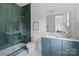 Elegant bathroom featuring glass enclosed shower, blue vanity, and modern fixtures at 3822 Topsfield Rd, Charlotte, NC 28211