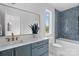 Bathroom featuring blue tiled walls, soaking tub, and vanity with white countertop at 3822 Topsfield Rd, Charlotte, NC 28211