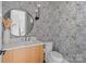 Stylish powder room featuring unique wallpaper, round mirror, and modern vanity at 3822 Topsfield Rd, Charlotte, NC 28211