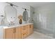 Bright bathroom featuring double vanity, quartz countertop, decorative mirrors, and glass-enclosed shower at 3822 Topsfield Rd, Charlotte, NC 28211