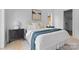 Cozy bedroom with soft decor, hardwood floors, and a view of the lush outdoors at 3822 Topsfield Rd, Charlotte, NC 28211