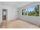 Bright bedroom with hardwood floors and large windows offering ample natural light and green views at 3822 Topsfield Rd, Charlotte, NC 28211