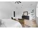 A naturally-lit bedroom with wood flooring, furniture, and windows overlooking a treed canopy at 3822 Topsfield Rd, Charlotte, NC 28211