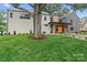 Landscaped front yard with an established tree and modern home facade at 3822 Topsfield Rd, Charlotte, NC 28211