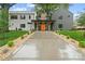 Modern home featuring manicured landscaping, a concrete driveway, and a striking orange front door at 3822 Topsfield Rd, Charlotte, NC 28211