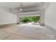 Spacious, two-car garage with overhead door, concrete floors, and ample natural light at 3822 Topsfield Rd, Charlotte, NC 28211