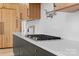 Modern kitchen featuring high-end appliances, custom cabinetry, and a sleek cooktop at 3822 Topsfield Rd, Charlotte, NC 28211