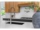 Stylish kitchen island with a modern faucet, a sleek black sink and white countertop at 3822 Topsfield Rd, Charlotte, NC 28211