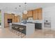 Bright kitchen showcasing an island with seating and custom wood cabinets at 3822 Topsfield Rd, Charlotte, NC 28211