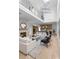 Open-concept living room with fireplace, showcasing a modern kitchen and second-story balcony at 3822 Topsfield Rd, Charlotte, NC 28211