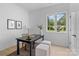 Bright office with a large window, sleek black desk, and hardwood flooring at 3822 Topsfield Rd, Charlotte, NC 28211