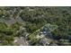 Lakefront aerial view showcasing a modern house nestled among mature trees and other beautiful homes at 386 Squirrel Ln, Lake Wylie, SC 29710