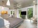 Bright bedroom featuring large windows with wooded views, a ceiling fan, and modern gray tones at 386 Squirrel Ln, Lake Wylie, SC 29710