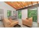 Open living room with vaulted ceilings, wood beams, and large windows with nature views at 386 Squirrel Ln, Lake Wylie, SC 29710