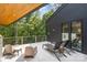 Outdoor patio with lounge chairs, seating area, and treetop views, perfect for relaxation and entertainment at 386 Squirrel Ln, Lake Wylie, SC 29710