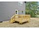 Rear view of back deck with railings attached to home with siding at 401 W Charlotte Ave, Mount Holly, NC 28120