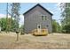 Rear view of home featuring a small wooden deck and partial fencing at 401 W Charlotte Ave, Mount Holly, NC 28120