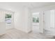 Bright bedroom with neutral carpet and trim; featuring a window and doorways at 401 W Charlotte Ave, Mount Holly, NC 28120