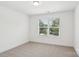 Sun-lit bedroom with plush carpeting and a large window at 401 W Charlotte Ave, Mount Holly, NC 28120