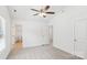Bedroom with ceiling fan, neutral carpet, two closets, and bathroom access at 401 W Charlotte Ave, Mount Holly, NC 28120