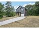 Two-story home featuring a charming front porch, a garage, and modern siding at 401 W Charlotte Ave, Mount Holly, NC 28120