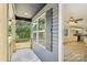 Covered front porch showcasing wood columns, a window with shutter, and a glimpse into the living area at 401 W Charlotte Ave, Mount Holly, NC 28120