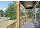 Covered front porch showcasing wood columns and natural wood railing at 401 W Charlotte Ave, Mount Holly, NC 28120