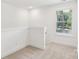Cozy hallway space that offers neutral carpeting and a sunlit window view at 401 W Charlotte Ave, Mount Holly, NC 28120