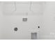 A modern laundry room showcasing white walls and space for a washing machine and dryer at 401 W Charlotte Ave, Mount Holly, NC 28120