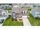 Aerial view showcasing a two-story home with a landscaped yard, two-car garage, and neighborhood setting at 4029 Spring Garden St, Fort Mill, SC 29715