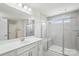 Modern bathroom with double vanity, large mirror, and glass-enclosed shower with shower seat at 4029 Spring Garden St, Fort Mill, SC 29715