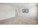 Bright bedroom with neutral walls, carpet, and a wall-mounted TV showcasing the home's exterior at 4029 Spring Garden St, Fort Mill, SC 29715
