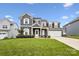 Charming home featuring a lush green lawn, two-car garage, and classic architectural design at 4029 Spring Garden St, Fort Mill, SC 29715