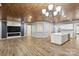 Spacious living room with hardwood floors, custom ceiling, fireplace, and open to kitchen at 4029 Spring Garden St, Fort Mill, SC 29715