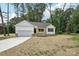 Charming home featuring a white exterior, front porch, and attached two-car garage at 403 W Charlotte Ave, Mount Holly, NC 28120