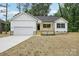 Charming single-Gathering home with a well-manicured lawn and a spacious two-car garage at 403 W Charlotte Ave, Mount Holly, NC 28120