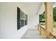 Cozy covered front porch features a stylish railing with a view of the front yard at 403 W Charlotte Ave, Mount Holly, NC 28120