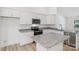 Updated kitchen with stainless appliances, granite counters, and an island at 403 W Charlotte Ave, Mount Holly, NC 28120