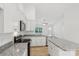 Bright kitchen featuring stainless appliances, granite countertops, and white cabinets at 403 W Charlotte Ave, Mount Holly, NC 28120