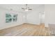 Bright living room features wood-look flooring, neutral walls, and a modern ceiling fan at 403 W Charlotte Ave, Mount Holly, NC 28120