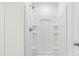 All-white shower with built-in shelving and brushed nickel fixtures at 403 W Charlotte Ave, Mount Holly, NC 28120