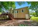 Exterior view of the home's backyard showing a wooden deck with steps at 4612 Saxonbury Way, Charlotte, NC 28269