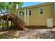 View of the backyard exterior showing a wooden deck with steps and the home's siding at 4612 Saxonbury Way, Charlotte, NC 28269