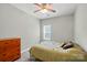 Bedroom featuring hardwood floors, a ceiling fan, and a wooden dresser at 4612 Saxonbury Way, Charlotte, NC 28269