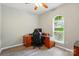 Bedroom featuring hardwood floors, a ceiling fan, a workstation, and a window at 4612 Saxonbury Way, Charlotte, NC 28269
