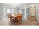 Spacious dining area with modern gray walls and elegant wood furniture at 4612 Saxonbury Way, Charlotte, NC 28269