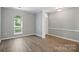 Light and airy dining room with gray walls and wide plank floors at 4612 Saxonbury Way, Charlotte, NC 28269