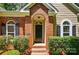 Inviting entryway featuring a red brick surround and classic black door at 4612 Saxonbury Way, Charlotte, NC 28269
